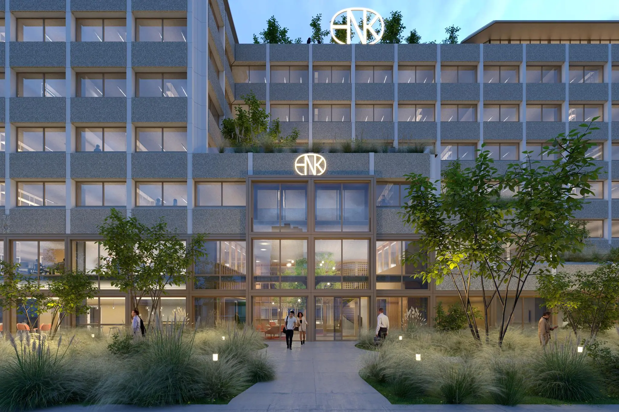 Moderne kantoorgebouw aan de Marten Meesweg met glazen entree, gevelverlichting en omliggende groene beplanting.